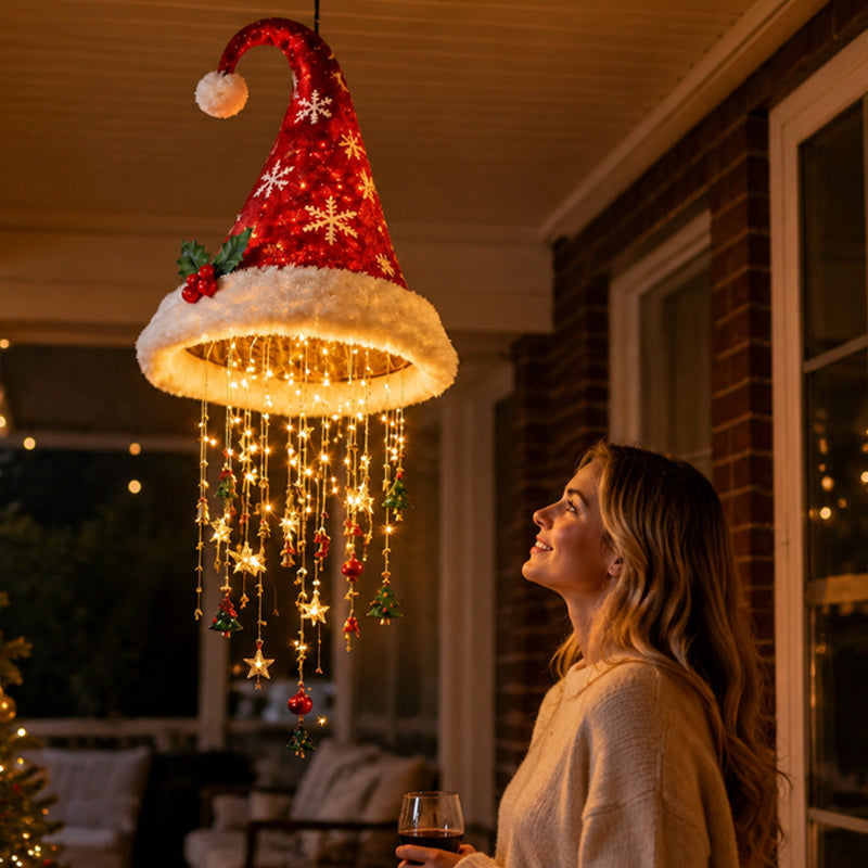 Red Santa hat hanging light with warm glowing strands in a cozy holiday room