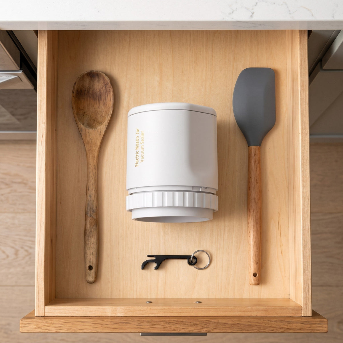 The sealer stored in a kitchen drawer with the keychain opener