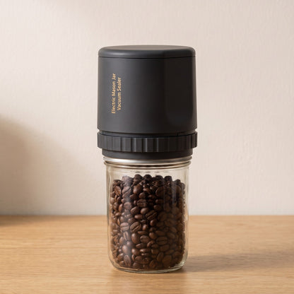 Alva Oro Mason jar vacuum sealer in black on a jar of coffee beans